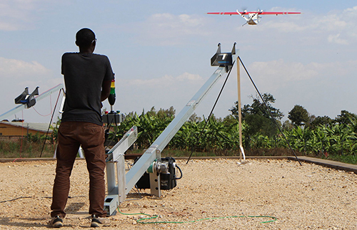 A Zipline worker technician launches a drone in Muhanga. (Photo copyright: Stephanie Aglietti/AFP/Getty Images. Caption copyright: The Guardian.)